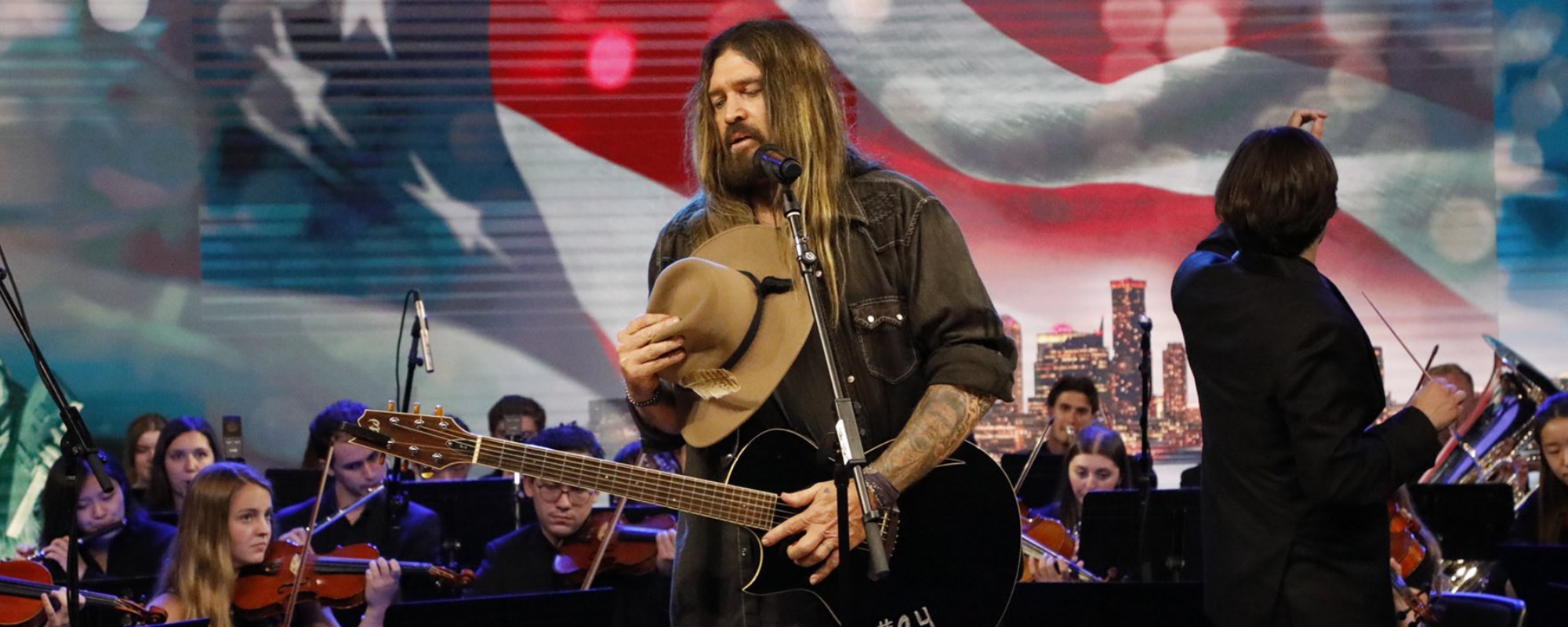 Billy Ray Cyrus Covers Neil Diamond’s “America” & Performs “Achy Breakey Heart” with New York Youth Symphony