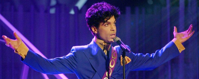 Prince, known for songs like "When Doves Cry," pictured performing onstage.