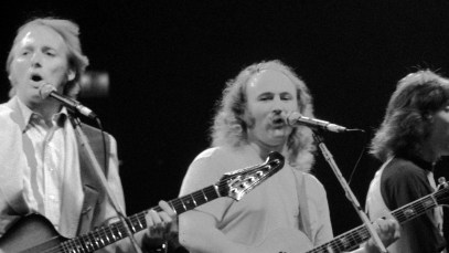 Crosby, Stills & Nash performing on stage together.