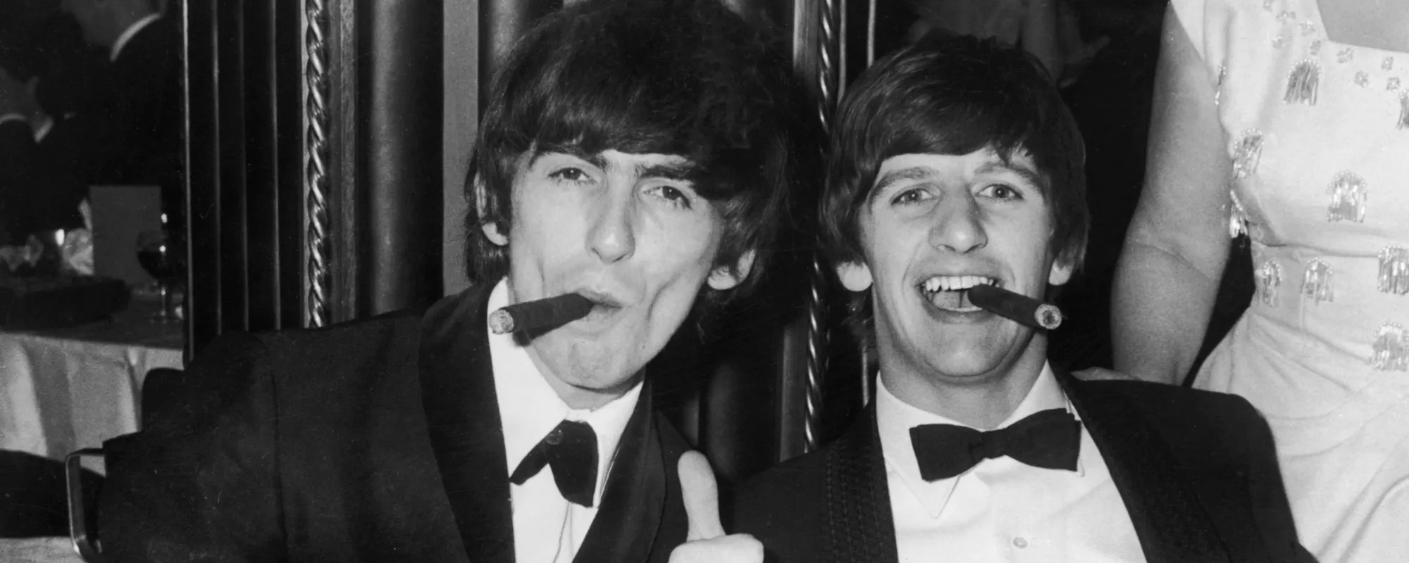 George Harrison and Ringo Starr smoking cigars together in 1964 London.