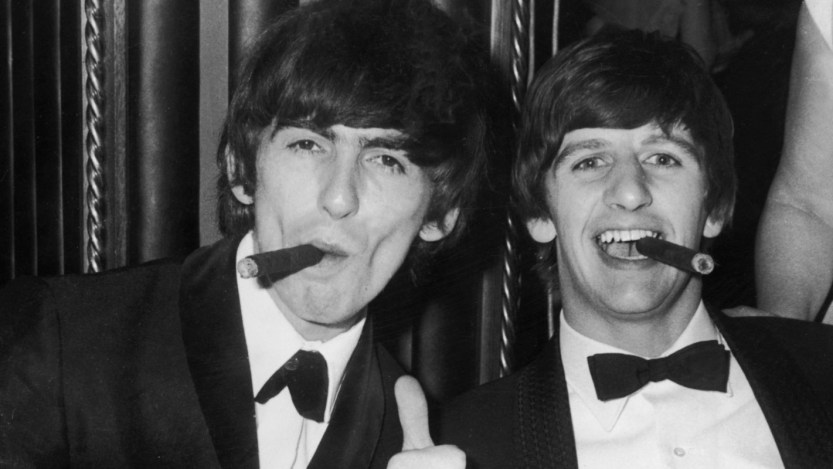 George Harrison and Ringo Starr smoking cigars together in 1964 London.