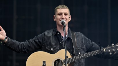 Nathan Evans, known for his rendition of The Wellerman, performs on stage with his guitar in Glasgow, Scotland.