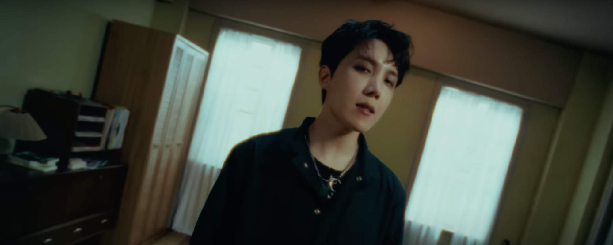 BTS member j-hope sings in his "MORE" music video before his debut solo album release.