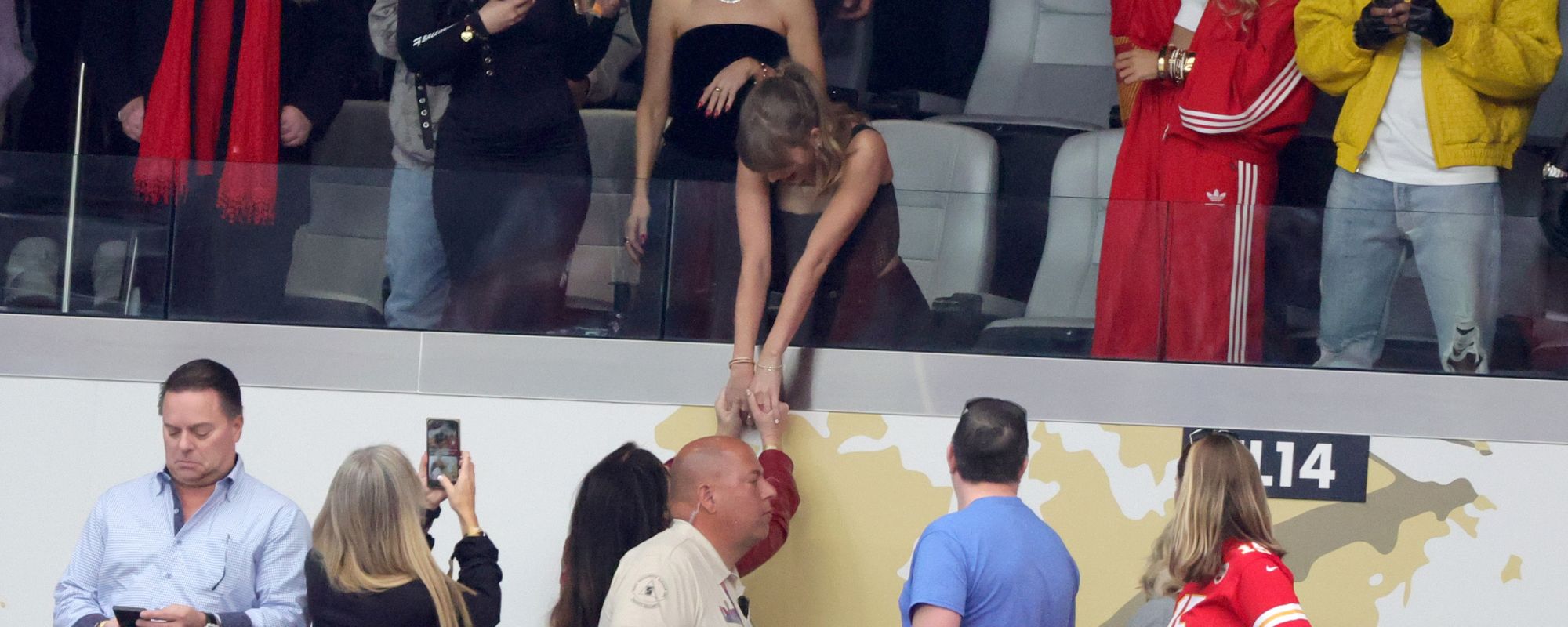 Taylor Swift interacts with a fan at Super Bowl LVIII in February 2024.