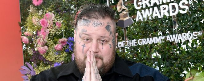 Jelly Roll folds his hands in prayer at a pre-GRAMMY event in February 2024.