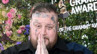Jelly Roll folds his hands in prayer at a pre-GRAMMY event in February 2024.