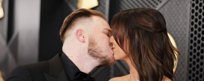 Zach Bryan kisses girlfriend Brianna LaPaglia at the 66th annual GRAMMY Awards.