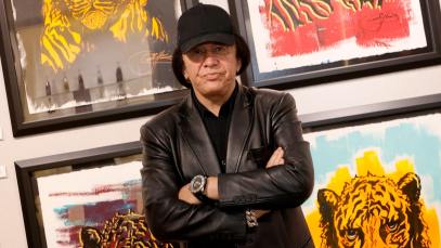 Kiss singer/bassist Gene Simmons poses in front of some of his works at the debut of Gene Simmons ArtWorks at Animazing Gallery at The Venetian Las Vegas on October 21, 2021 in Las Vegas, Nevada.