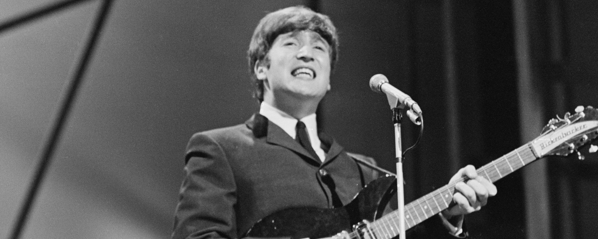 John Lennon singing, playing guitar