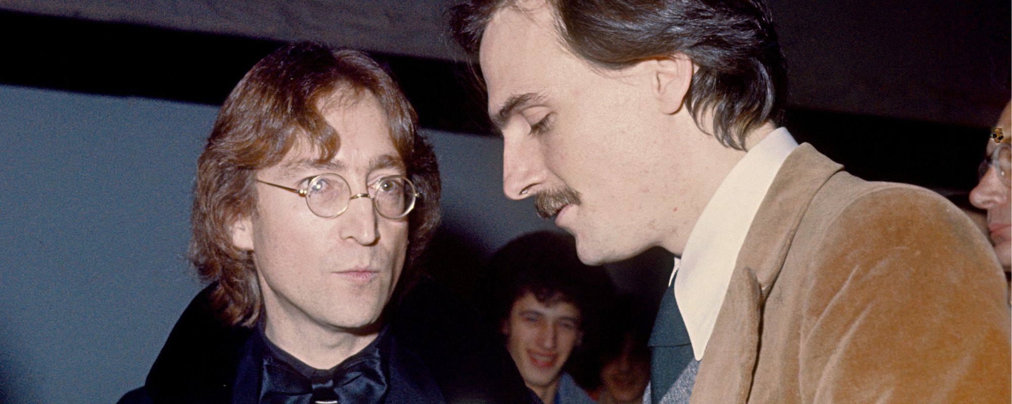 John Lennon and James Taylor speaking to one another