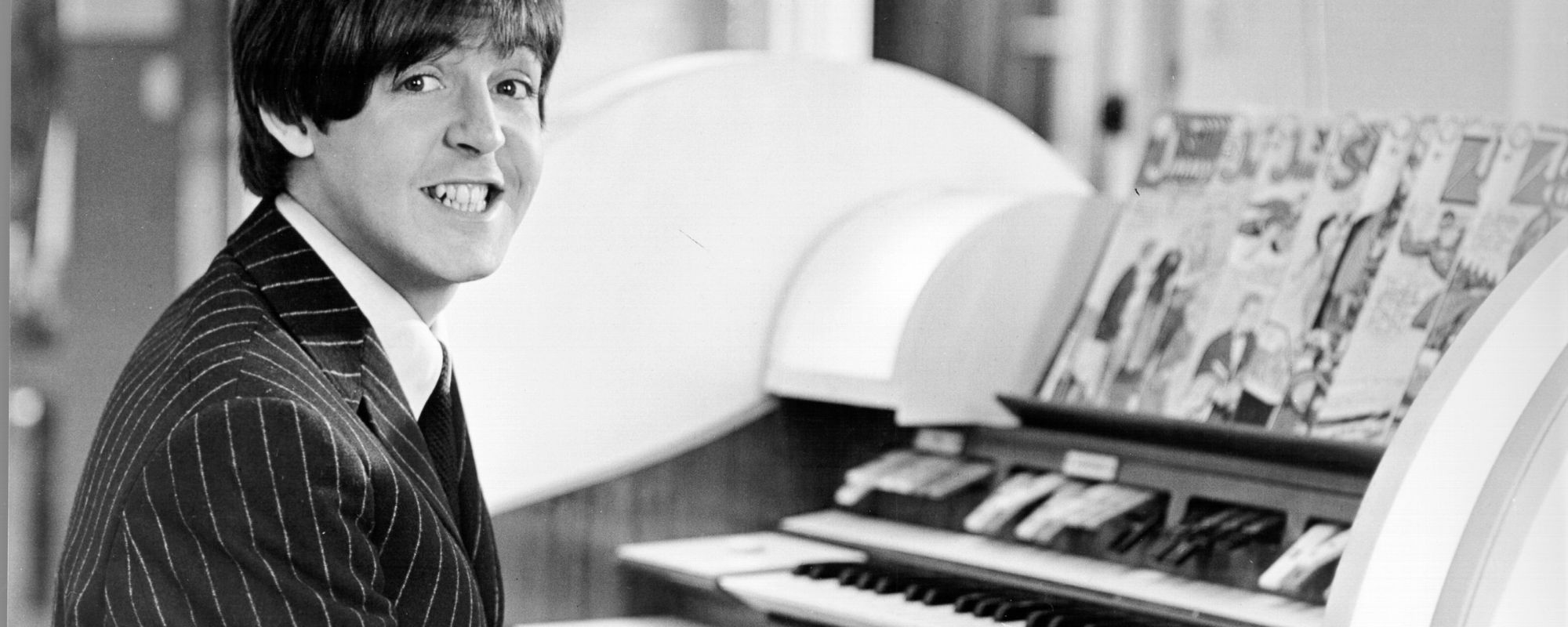 Paul McCartney smiles at piano