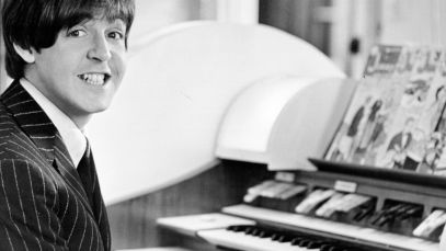 Paul McCartney smiles at piano