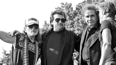 the Highwaymen, from left, Willie Nelson, Waylon Jennings, Johnny Cash (1932 - 2003), and Kris Kristofferson, embrace onstage at Central Park SummerStage, New York, New York, May 23, 1993.