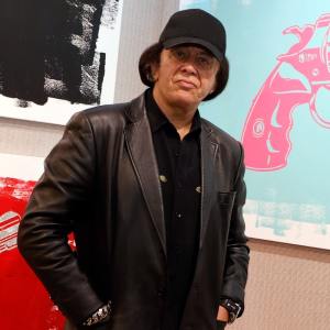 Kiss singer/bassist Gene Simmons poses with some of his works at the debut of Gene Simmons ArtWorks at Animazing Gallery at The Venetian Las Vegas on October 21, 2021 in Las Vegas, Nevada.