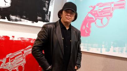 Kiss singer/bassist Gene Simmons poses with some of his works at the debut of Gene Simmons ArtWorks at Animazing Gallery at The Venetian Las Vegas on October 21, 2021 in Las Vegas, Nevada.