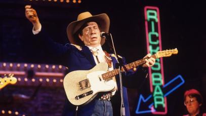 Buck Owens performs on stage at the Country Music Festival held at Wembley Arena, London in April 1989.