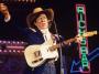 Buck Owens performs on stage at the Country Music Festival held at Wembley Arena, London in April 1989.