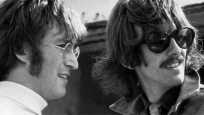 John Lennon and George Harrison standing side by side