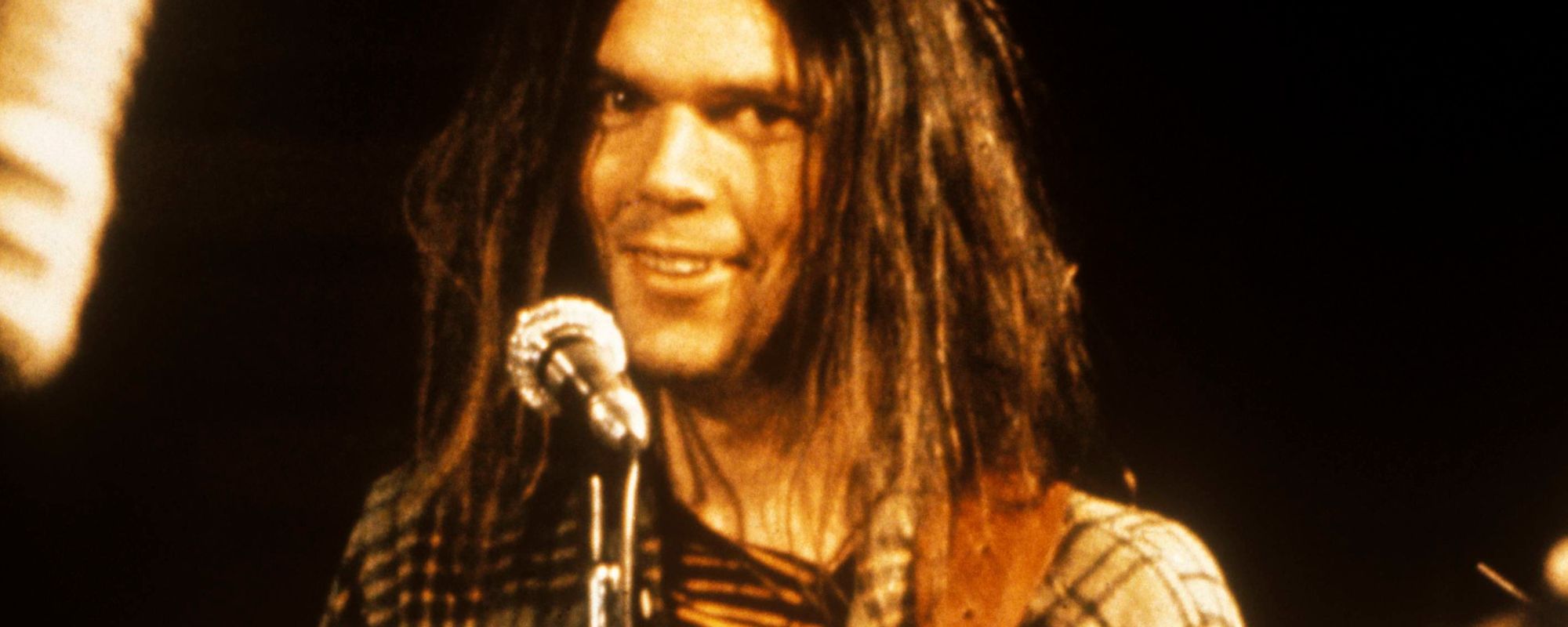 Neil Young smiling at mic