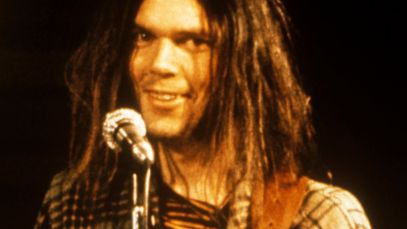 Neil Young smiling at mic