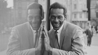 Chuck Berry smiling next to reflection of himself