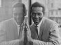 Chuck Berry smiling next to reflection of himself