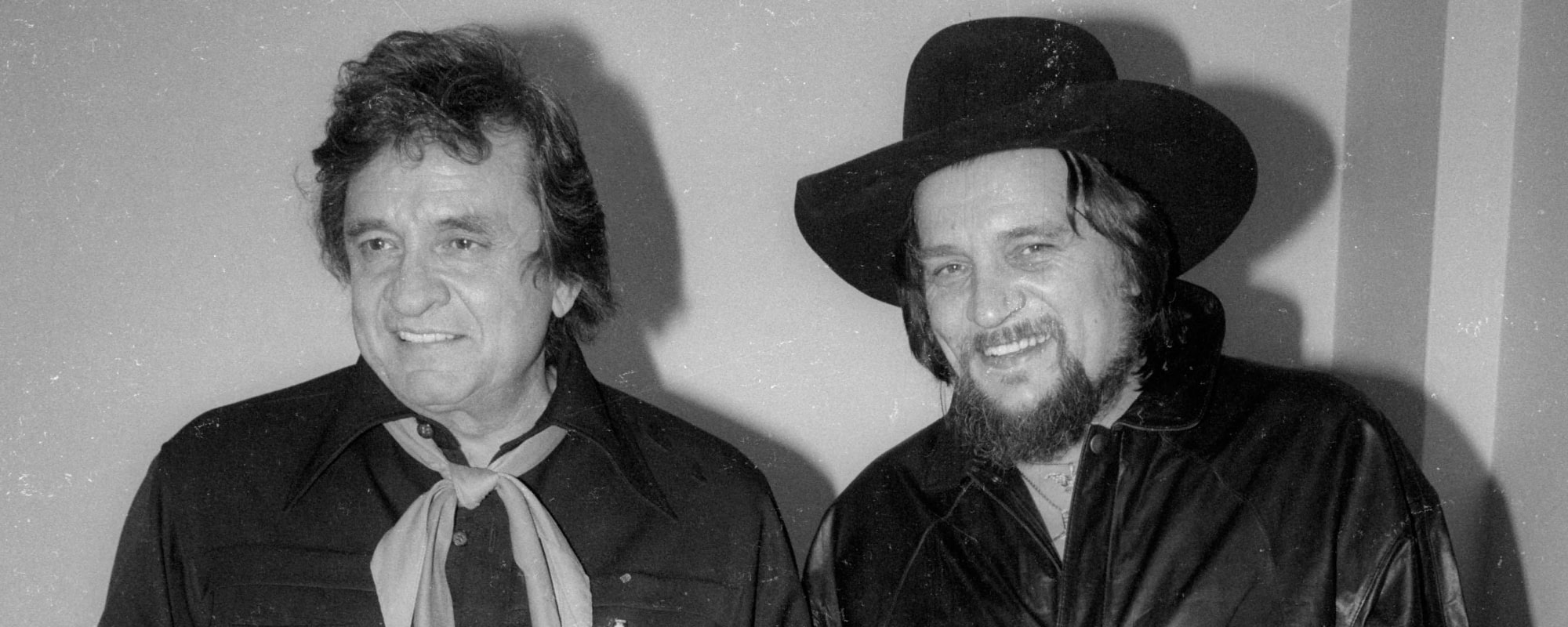 Watch Johnny Cash and Waylon Jennings Team Up for “Folsom Prison Blues” at the Inaugural Farm Aid Concert in 1985 - American Songwriter