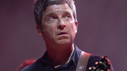 Noel Gallagher performing, looking up