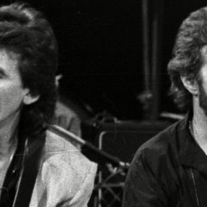 George Harrison and Eric Clapton sitting side by side