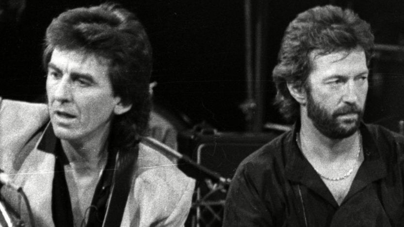 George Harrison and Eric Clapton sitting side by side