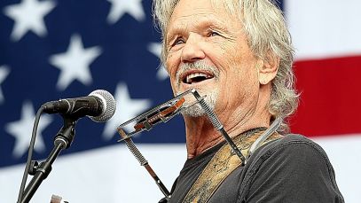 Kris Kristofferson performs in front of American flag