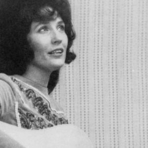 Loretta Lynn playing guitar