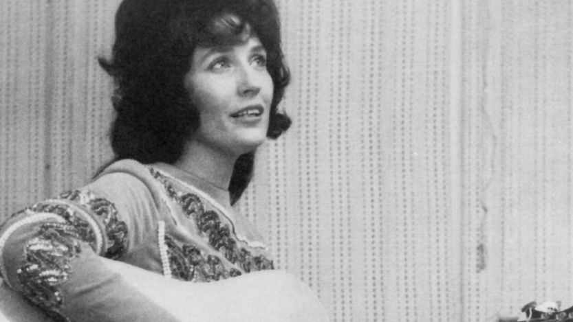 Loretta Lynn playing guitar