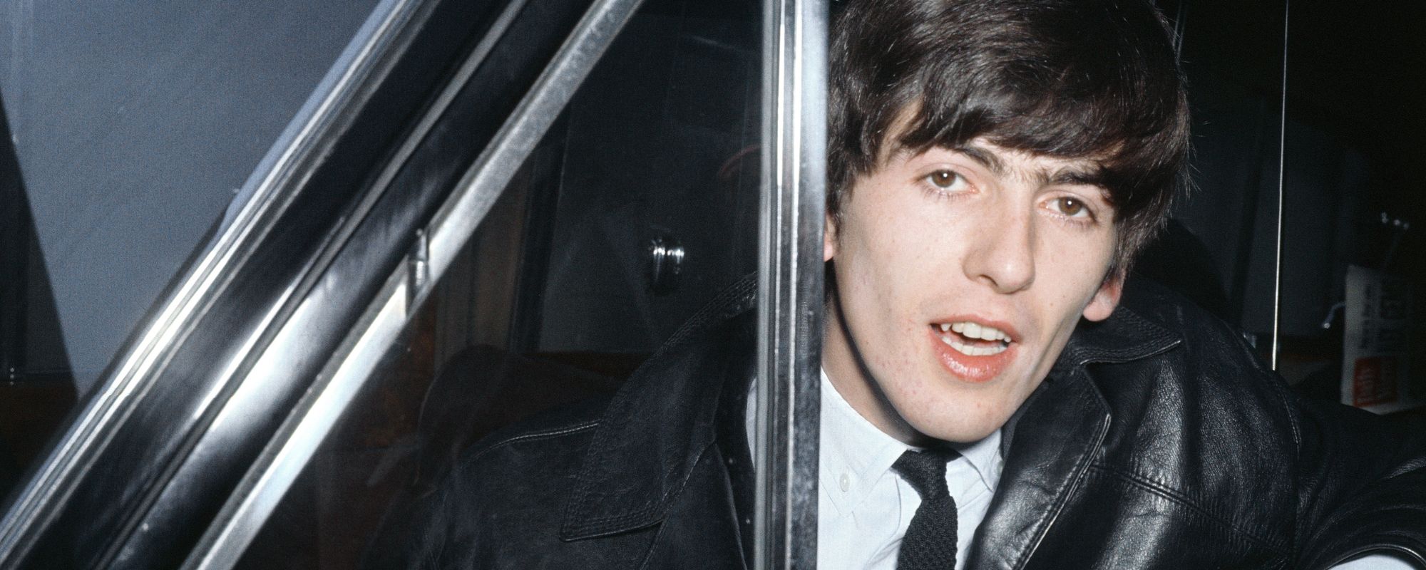 George Harrison leaning out of car window