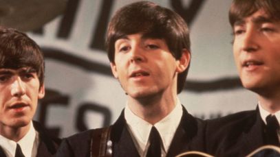 George Harrison, Paul McCartney, and John Lennon performing