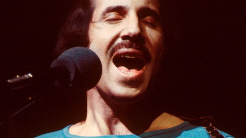 '60s folk singer Paul Simon performing songs
