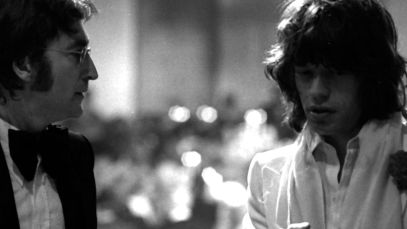 John Lennon and Mick Jagger standing together