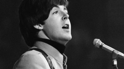 Paul McCartney, lead singer of "Here, There, and Everywhere," singing
