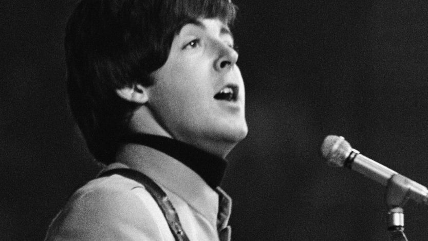Paul McCartney, lead singer of "Here, There, and Everywhere," singing