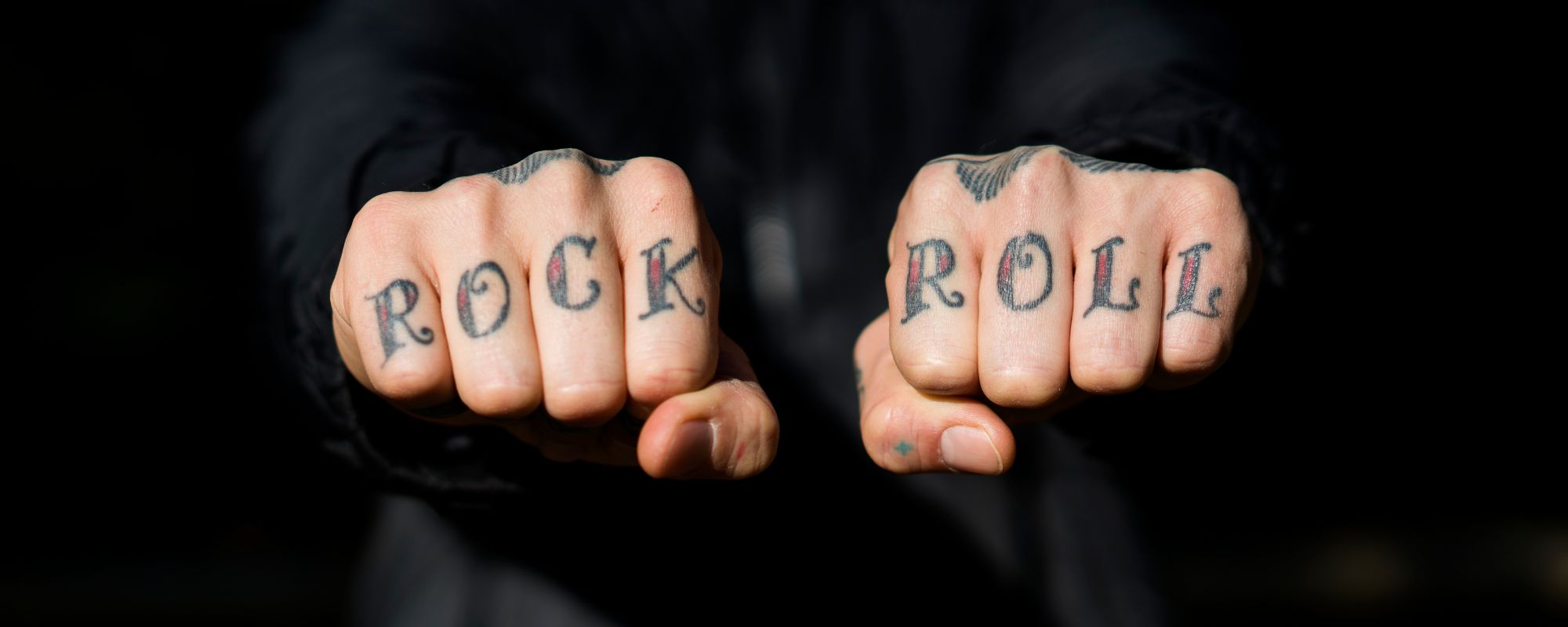"Rock" "roll" tattoos on knuckles