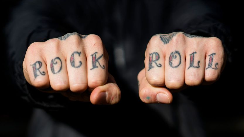 "Rock" "roll" tattoos on knuckles