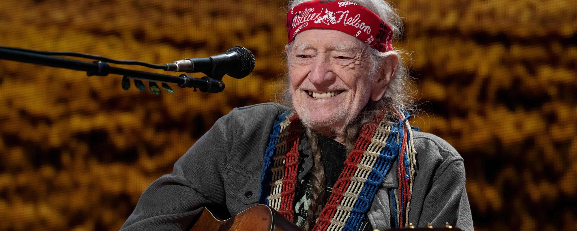 Willie Nelson smiling on stage