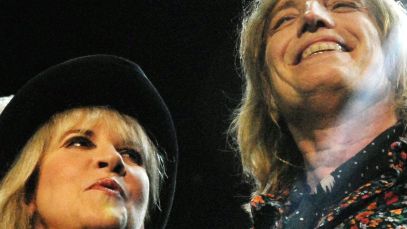 Stevie Nicks and Tom Petty standing together on stage