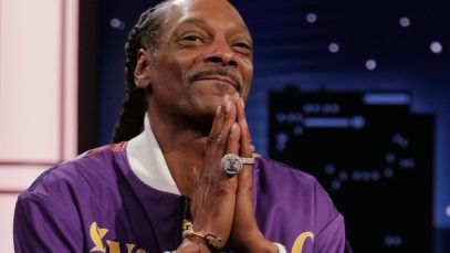 Snoop Dogg holding hands in front of face