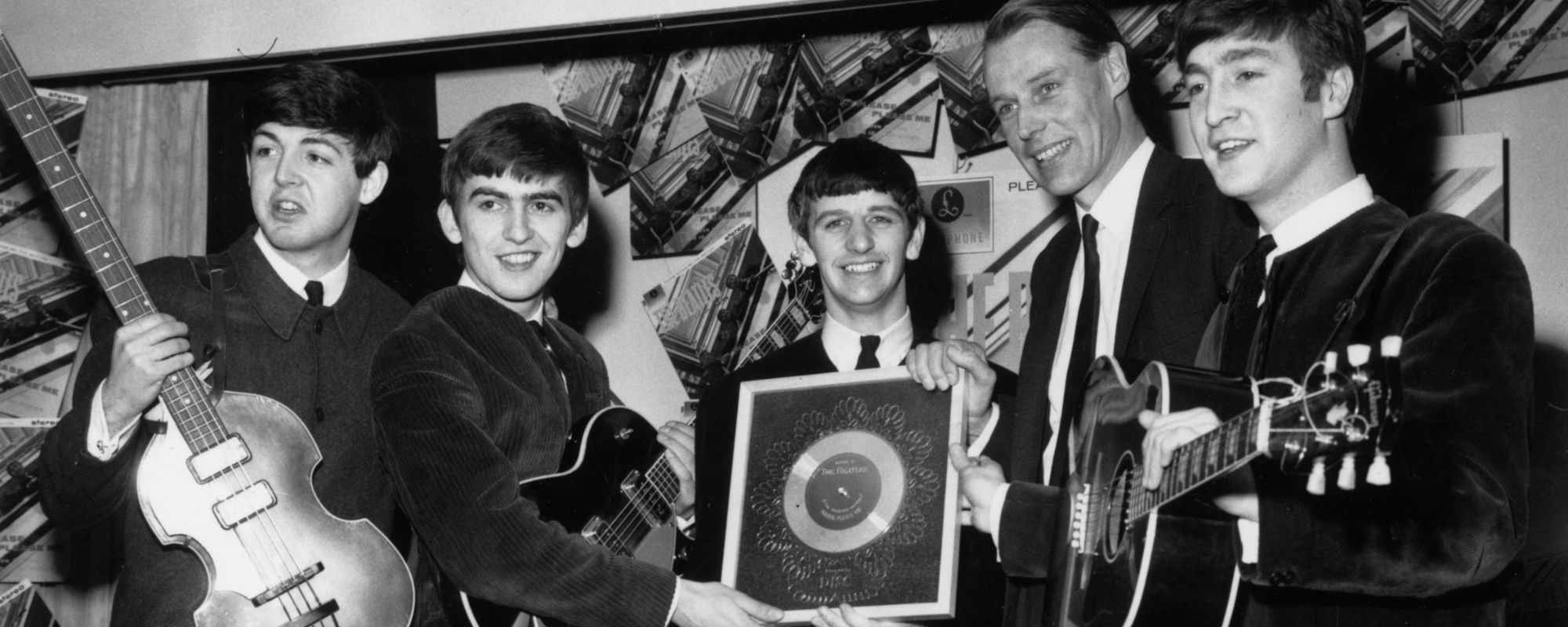 The Beatles pose with producer George Martin