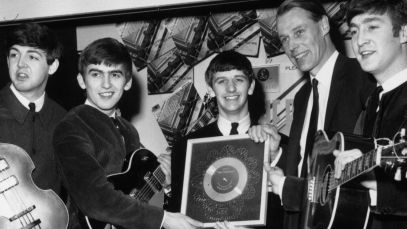 The Beatles pose with producer George Martin