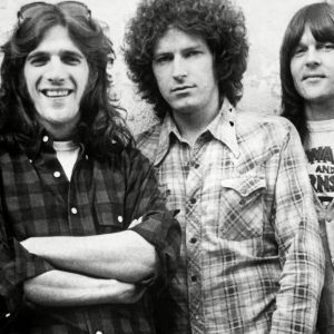 Eagles band posing by wall