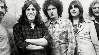 Eagles band posing by wall