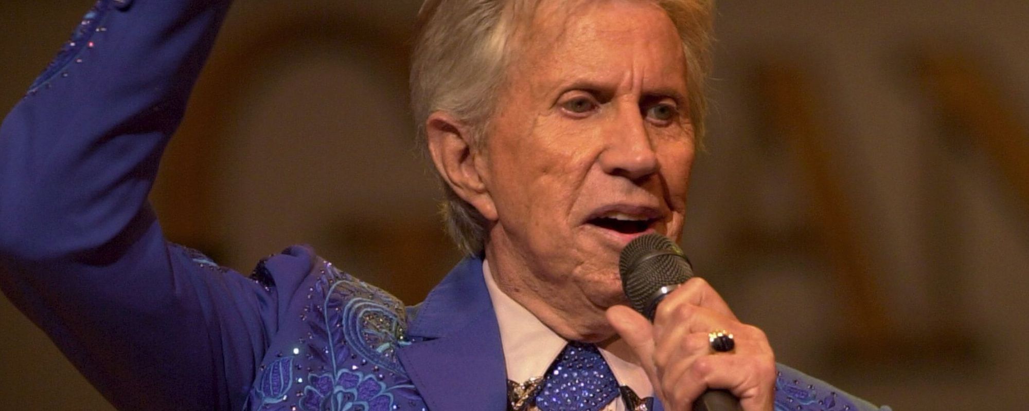 Porter Wagoner speaking into microphone