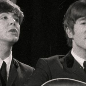 Paul McCartney and John Lennon of the Beatles performing